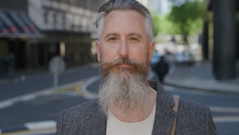 portrait of mature man looking at camera pensive caucasian male commuter businessman wearing stylish suit in urban city street beard fashion