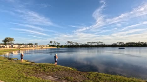 person fishing by a calm reflective lake