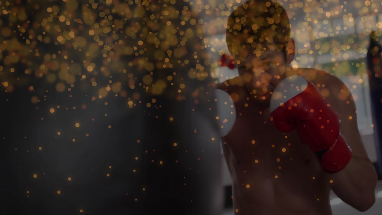 Male boxer raising guard, starting training, throwing jab,cross at bag, golden particles overlaying