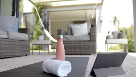 mature woman practicing yoga on patio