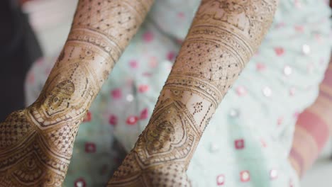 mehndi art applied on both hands of bride