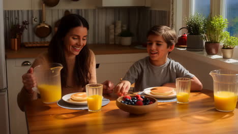 family breakfast scene with pancakes and orange juice