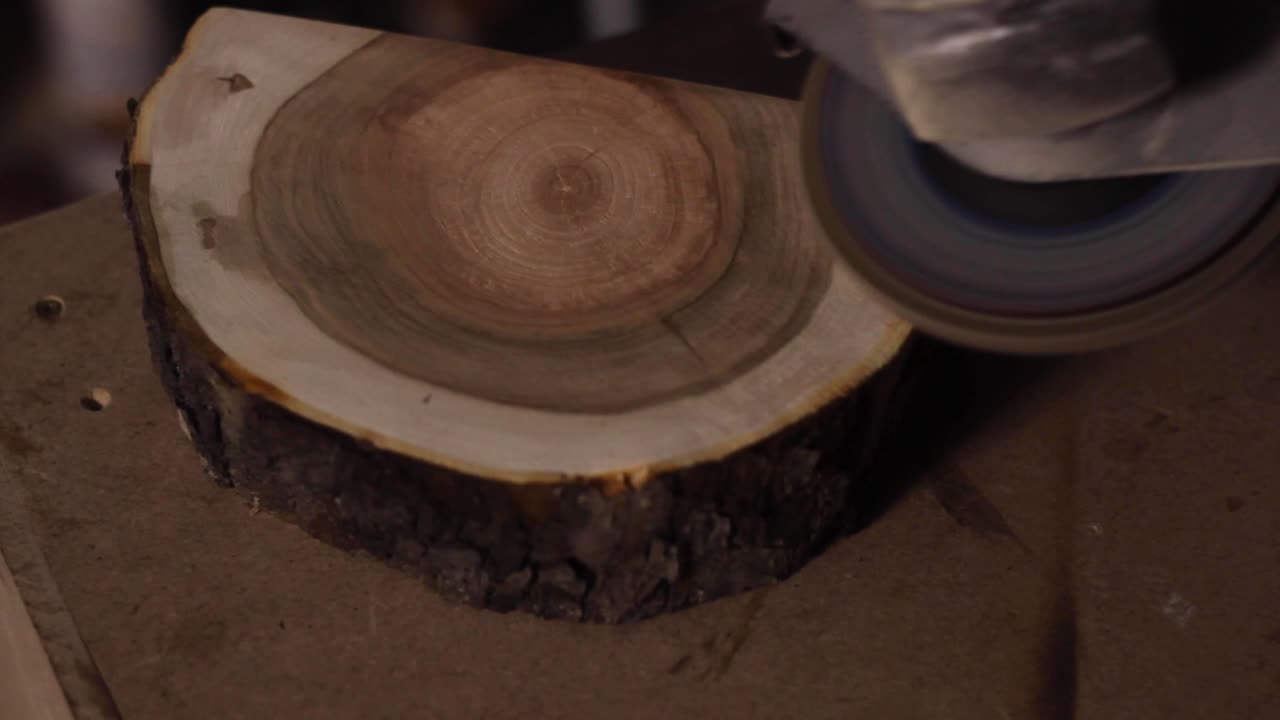 Close-up of Woodworking: Sanding a Wood Slice with an Angle Grinder