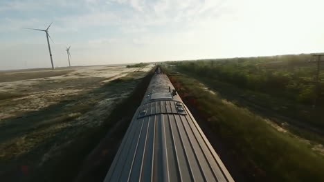 train journey through rural landscape with wind turbines