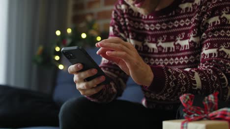 Mann-Benutzt-Mobiltelefon-Zu-Hause-Zur-Weihnachtszeit