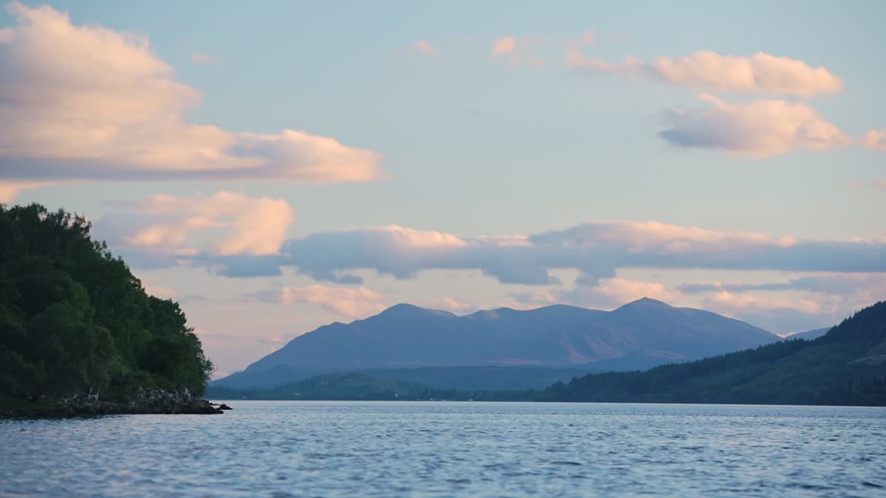 Landscape view of Loch Ness, Scotland, with mountains in the background, at dusk
