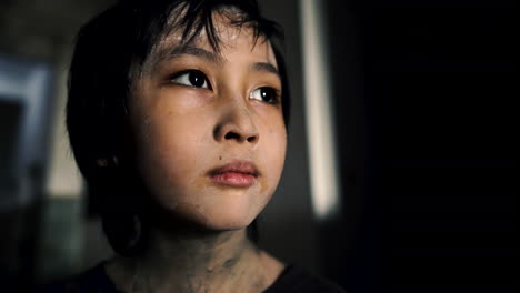 Homeless-dirty-boy-close-up-looking-into-distance