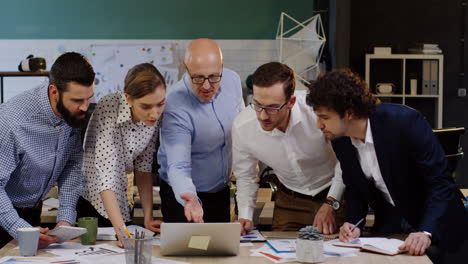 caucasian business team analyzing documents, charts, financial reports and graphics in the office