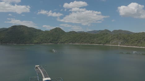 Cage-Tilapia-fish-farming-and-surrounding-landscape,-Hatillo-dam-in-Dominican-Republic