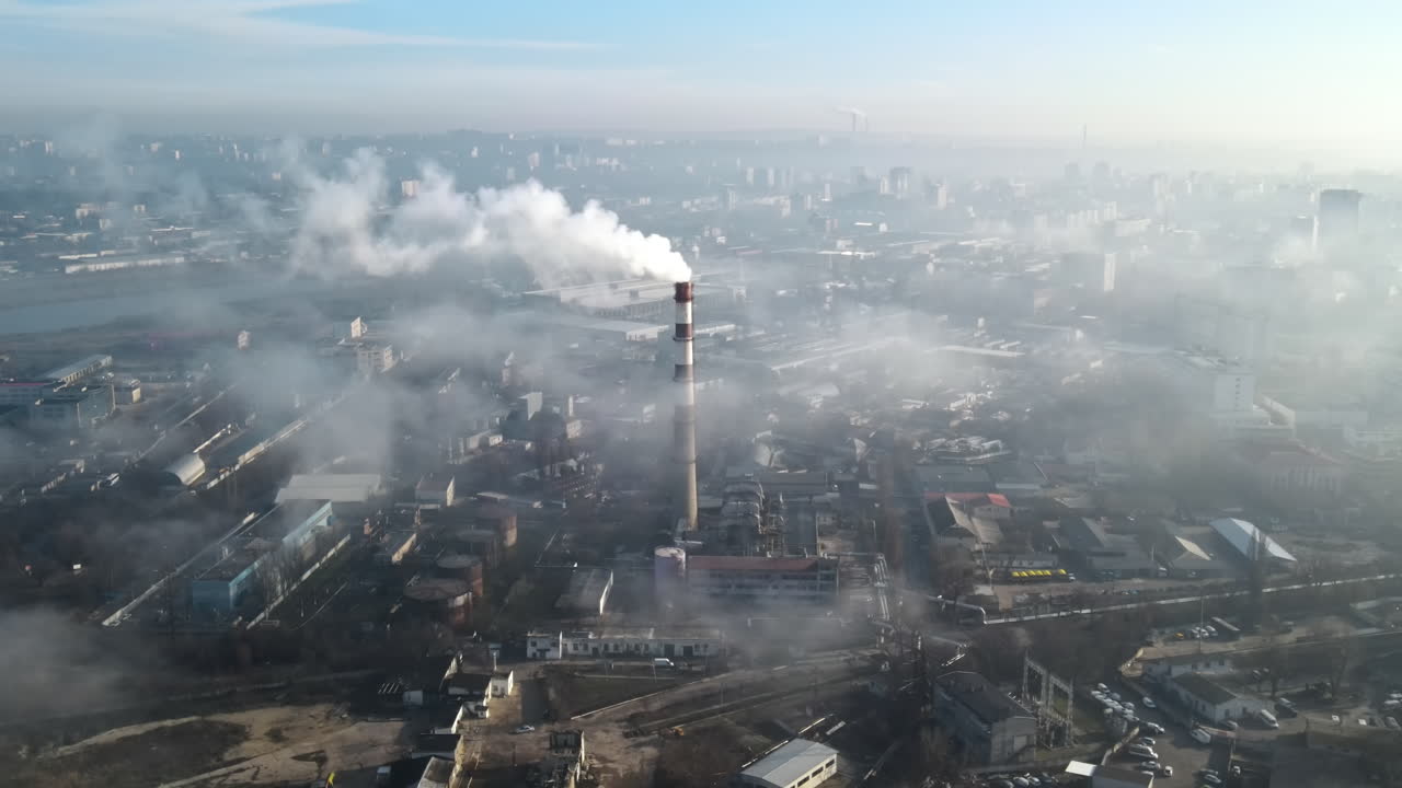 Aerial drone view of Chisinau. Thermal station with smoke coming out of the tube. Buildings, roads. Fog in the air. Moldova