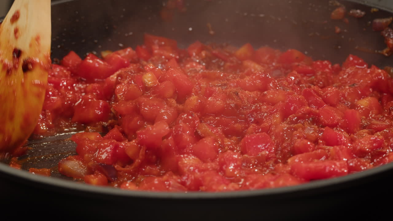 Tomatoes cooking in frying pan
