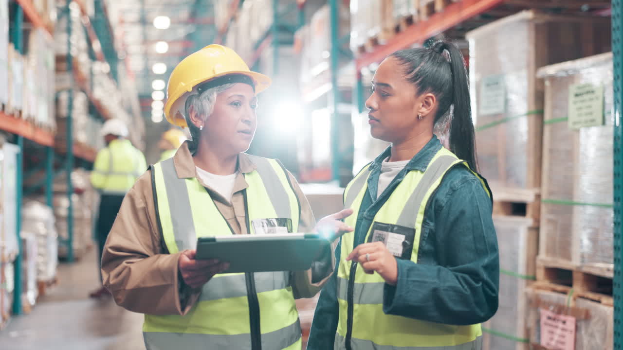 Warehouse employees discussing inventory