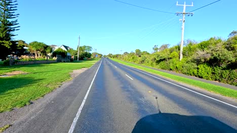 a car journey along a sunny, tree-lined road in bellarine, victoria, showcasing serene landscapes and clear skies