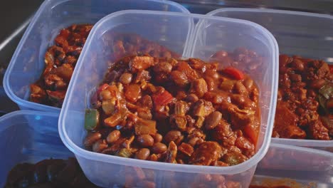 cooked spicy chicken beans prepared in a plastic food container