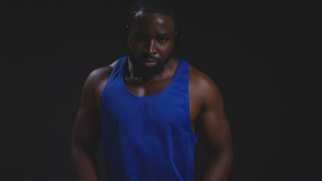 Close-Up-Studio-Shot-Of-Male-Boxer-Training-In-Gym-Sparring-Towards-Camera-Preparing-For-Fight-Against-Black-Background