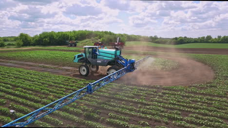 Agricultural-sprayer-watering-fertilizer-on-farming-field.-Agricultural-industry