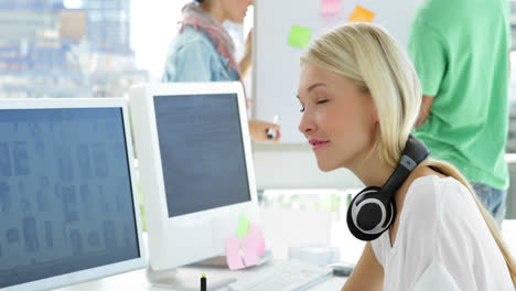 Lovely-focused-creative-designer-working-on-her-computer-