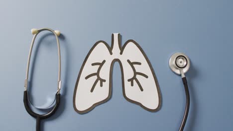 Video-of-close-up-of-stethoscope-with-lungs-on-blue-background