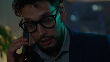 businessman talking on smartphone at night