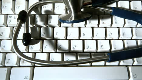 Stethoscope-falling-onto-computer-keyboard-and-then-vibrating