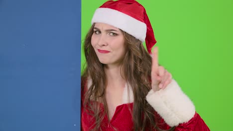 Woman in Santa Claus Costume Pointing and Disapproving