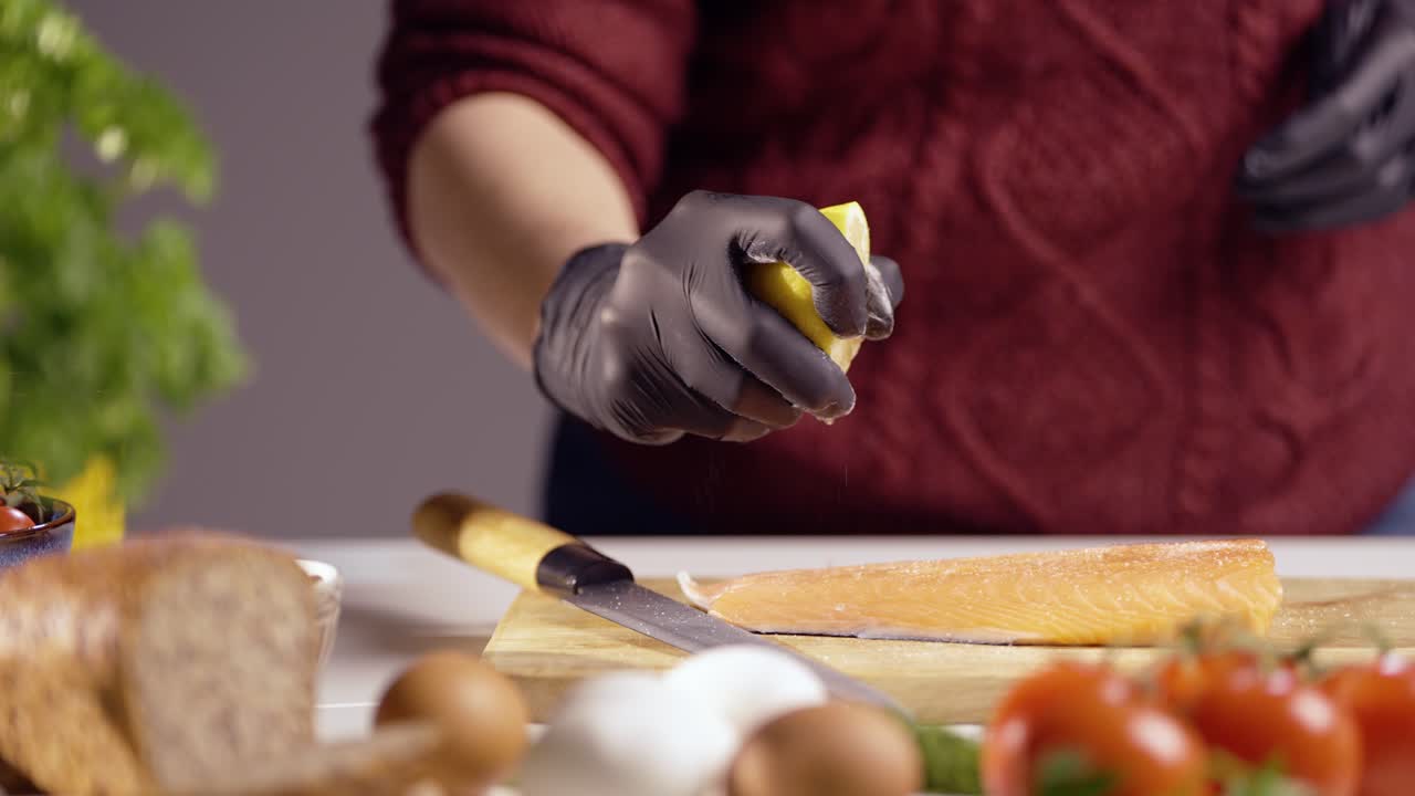 A chef squeezes lemon juice over a fresh salmon fillet. Citrus drops enhance the rich texture of the fish. Perfect for cooking, seafood, and gourmet cuisine themes in stunning 4K quality