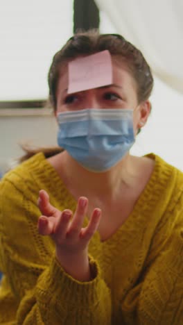 vertical video: happy woman gesturing playing name game with multiethnic friends