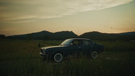 vintage car at sunset in a country field