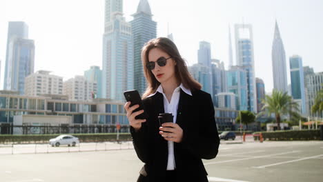 elegant businesswoman with phone outdoors