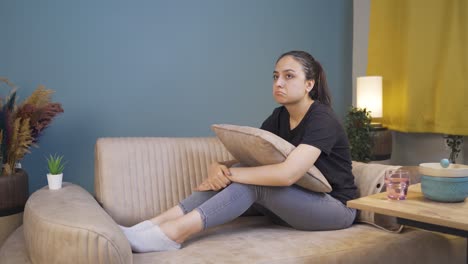 Depressed-young-woman-lying-on-the-sofa.