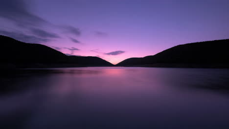 tranquil lake at twilight with purple and pink sky