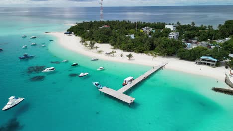 aerial drone footage flying backwards to reveal more of fulidhoo island in the maldives