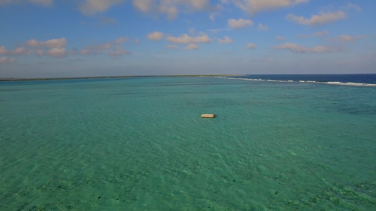 Aerial view of a tropical ocean with turquoise water and clear sky