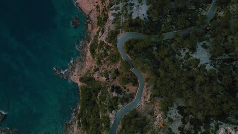 Modern-car-driving-at-scenic-coastal-winding-road-at-Es-Colomer-Island,-Cap-Formentor,-Mallorca,-Spain