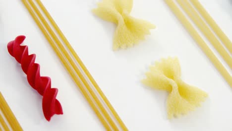 Farfalle-spaghetti-green-and-red-pasta-aligned-arranged-on-white-background