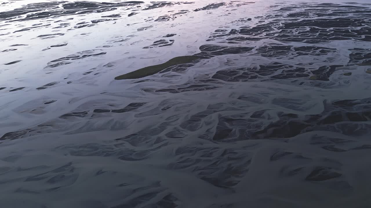 Glacial Braided River Flowing Through Volcanic Soil In South Iceland