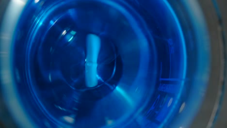 dissolving a pill in a blue solution