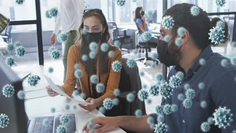 animation of covid 19 cells floating over businesspeople in face masks in office