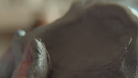 hands of sculptor modeling clay