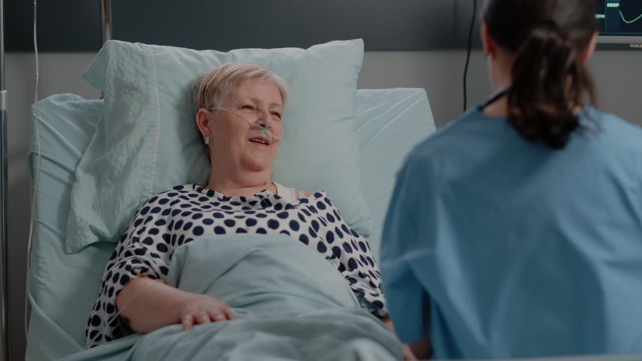 Senior woman talking to medical assistant about healthcare