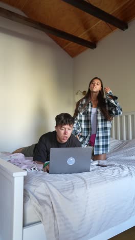 couple using laptop in bedroom