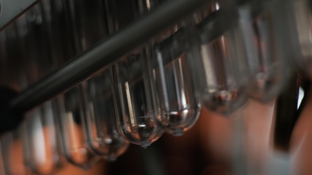 Automatic filling machine pours water into plastic PET bottles at modern beverage plant