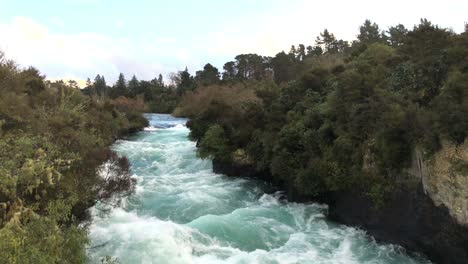 looking upstream against the current of huka falls near the town of taupo on the north island of new zealand, slow motion