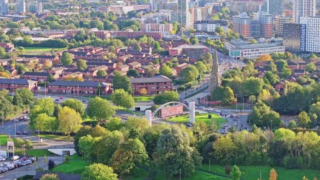 zoomed lifting drone shot of a densely populated neighborhood in manchester on a sunny day