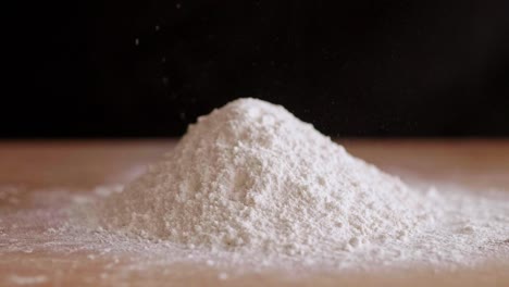 sifting flour on the wooden pastry board