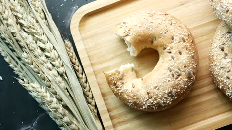 fresh bagel bread in a paper on table ,