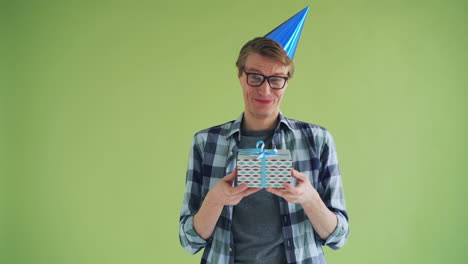man holding a gift with a party hat