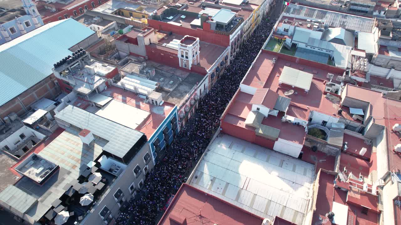 Aerial footage of the international women´s day march, the crowd in the streets of Puebla city historic center