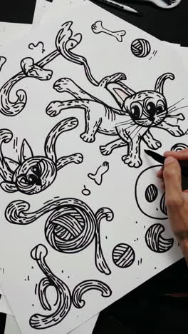 artist drawing doodle cats and yarn
