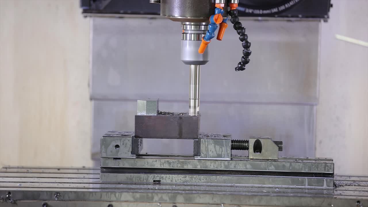 A high-precision CNC milling machine is captured mid-operation in a modern